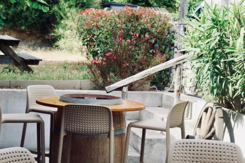 a wooden table and chairs on a patio at Résidence L'araguina in Bonifacio