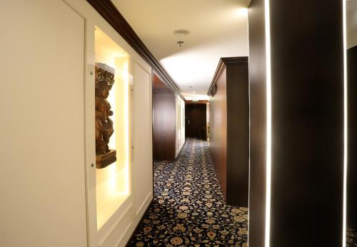 a hallway of a hotel with a long corridor at The Ambassador, Marine Drive, Mumbai in Mumbai
