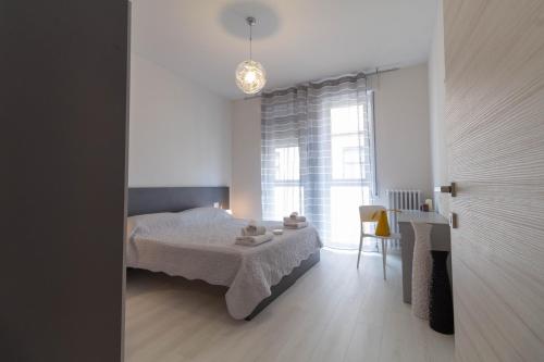 a bedroom with a bed and a table and a window at Le Casette Di Osvaldo in Lecco