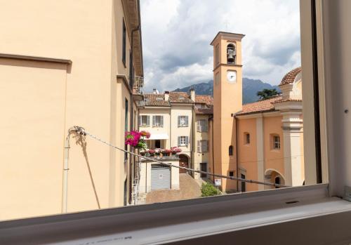 a view from a window of a city with a clock tower at Le Casette Di Osvaldo in Lecco