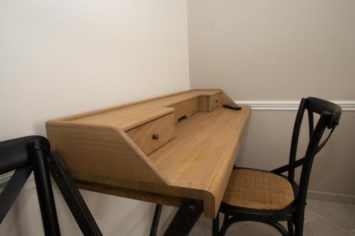 a wooden desk in a room with a chair at Champagne André Bergère - Guest House in Épernay