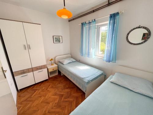 Postel nebo postele na pokoji v ubytování Apartmani Leonarda
