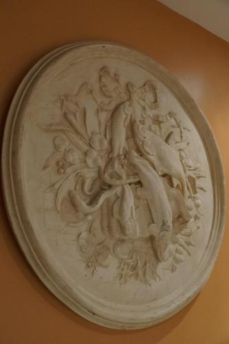 a white plate with a relief on a wall at Studio Rempart in Brussels