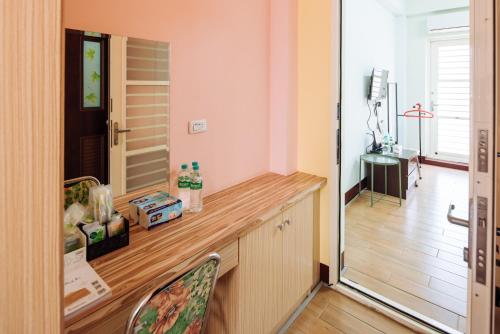 a room with a desk with a chair and a mirror at Urarakana B&B in Miaoli