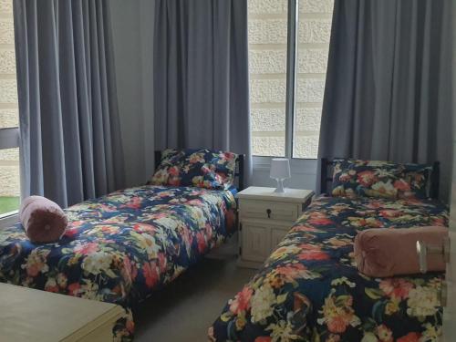 a bedroom with two beds and a window at EILAT GOLF RESIDENCE Apartment A 1 in Eilat