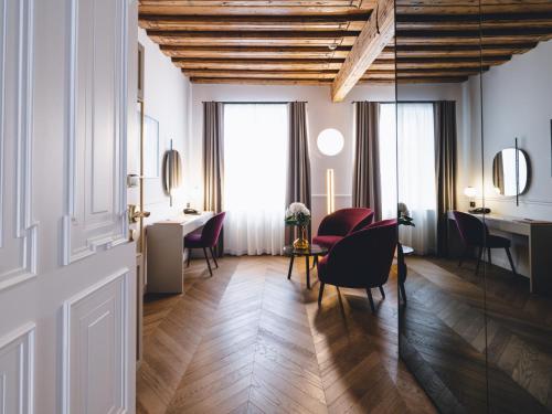 
a living room filled with furniture and a large window at Hotel Heritage in Ljubljana
