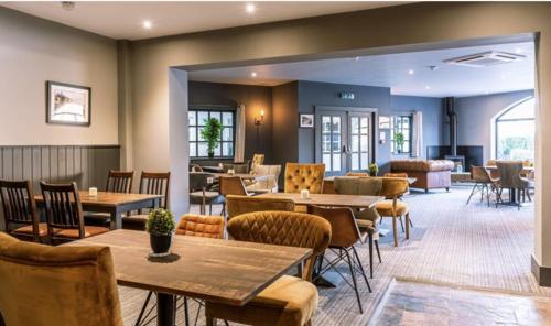 a dining room with tables and chairs at Saltwater Apartment in Filey