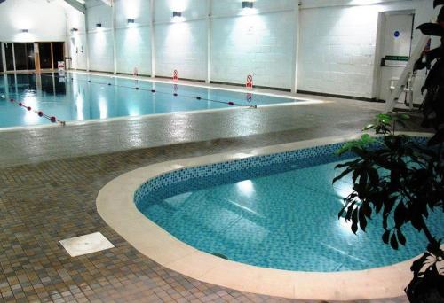 a swimming pool in a building with a large swimming pool at Saltwater Apartment in Filey