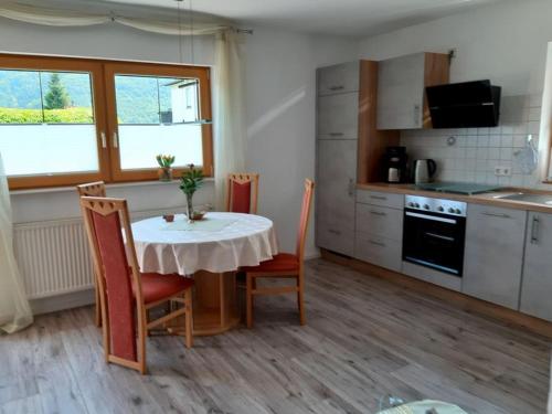 a kitchen with a table and chairs and a kitchen with a window at Ferienappartement Lieser in Bernkastel-Kues