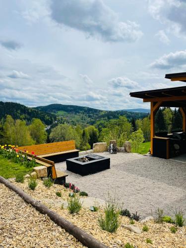 a patio with a fire pit and a pavilion at Wellness Chata Brejlovka in Janov nad Nisou