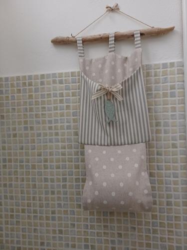 a bag with polka dots is hanging on a wall at Porta del Mare in Portoferraio