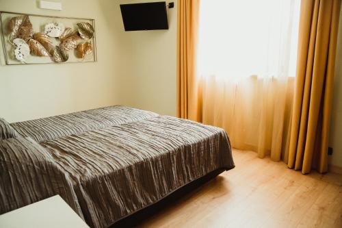 a small bedroom with a bed and a window at NIDO DEL GELSO in Verona