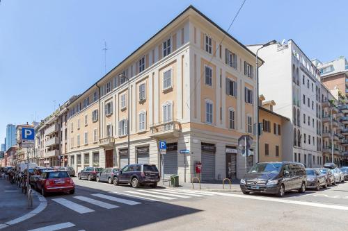 a large building on a city street with cars parked at Milan Retreats in Milan