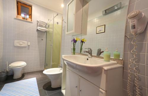a bathroom with a sink and a toilet at Villa Filipa in Cavtat