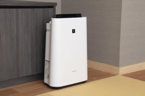 a white refrigerator sitting on the floor in a room at Tensui Saryo in Hakone