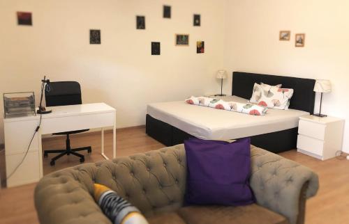 a living room with a couch and a bed at Lighthaus Apartment in Graz