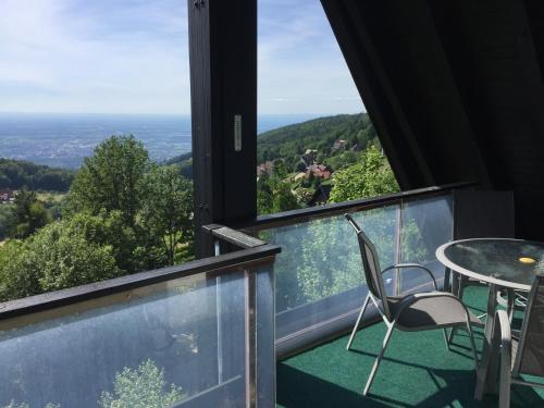 a balcony with a table and chairs and a view at Panorama Point in Sasbachwalden