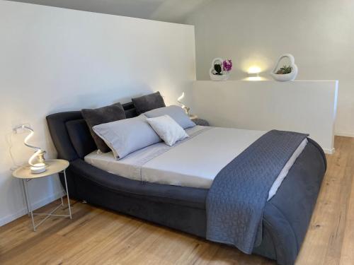 a bedroom with a large bed with two pillows at ON the RAIL by Arcotrilogy-Homes in Arco