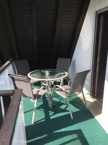 a table and chairs on a balcony with a table and chairs at Panorama Point in Sasbachwalden