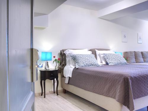 a bedroom with a bed and a table with a blue lamp at Aegli Arachova in Arachova