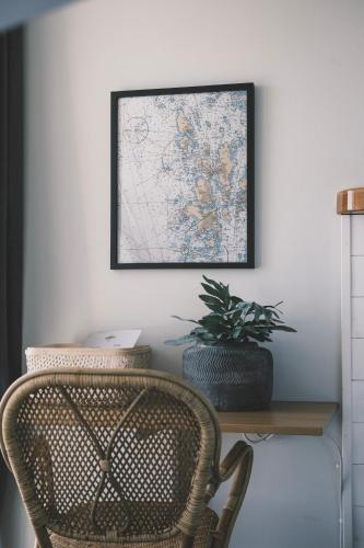 a desk with a chair and a map on the wall at Skärgårdshotellet Hönö in Hönö