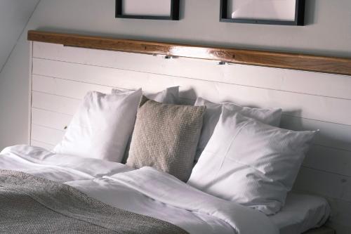 a bed with white sheets and pillows on it at Skärgårdshotellet Hönö in Hönö