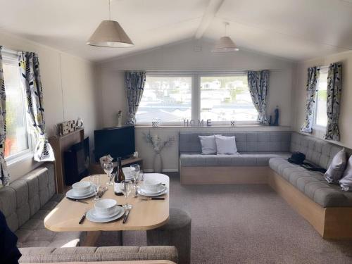 a living room with a couch and a table at pool-garden-2br-parking-wifi-sleeps6 in Paignton
