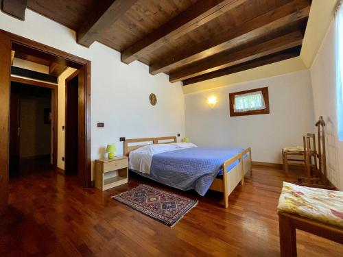 sypialnia z łóżkiem i drewnianą podłogą w obiekcie Alla Barchessa di Villa Querini w mieście Preganziol