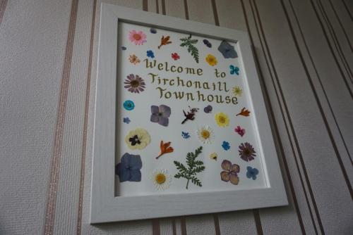 a framed picture of flowers on a wall at Tirchonaill Townhouse in Donegal