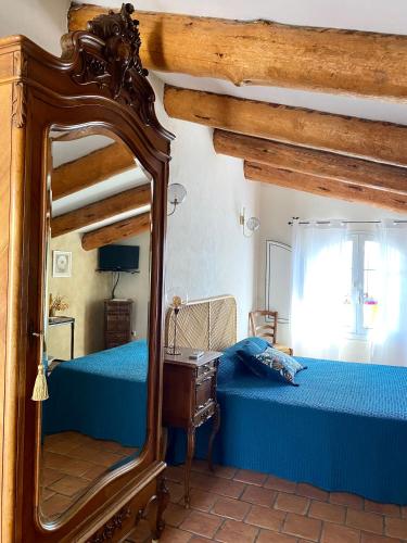 a bedroom with two beds and a mirror at Chambres d'hôtes et studios de charme - A Mandria in Murato