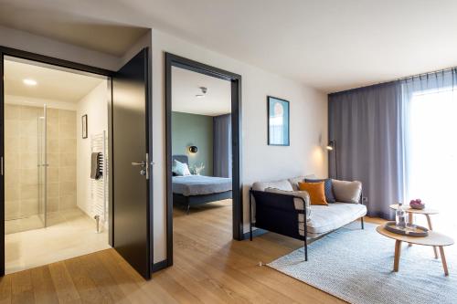 a living room with a couch and a bedroom at ipartment Böblingen Sindelfingen in Böblingen