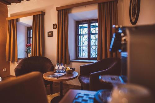 a room with chairs and a table and a window at Heritage Hotel Hallstatt in Hallstatt