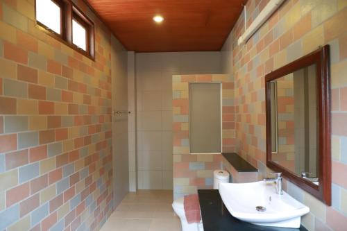 a bathroom with a sink and a mirror at Waterside Resort in Pran Buri