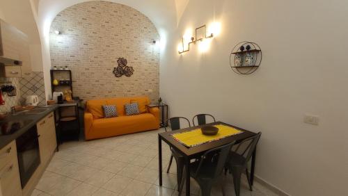 kuchnia z pomarańczową kanapą i stołem w obiekcie Casa Barocco Catania w Katanii