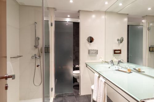 a bathroom with a shower and a sink and a toilet at Parador de La Granja in La Granja de San Ildefonso