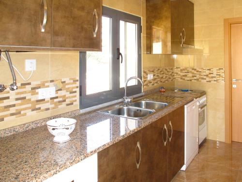 a kitchen with a sink and a counter top at Holiday Home Do Pinheiros by Interhome in Vau