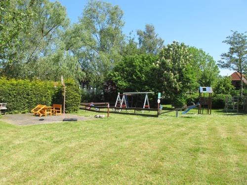 a park with a playground and a swing at Apartment Gollwitzer Park - Insel Poel-5 by Interhome in Gollwitz
