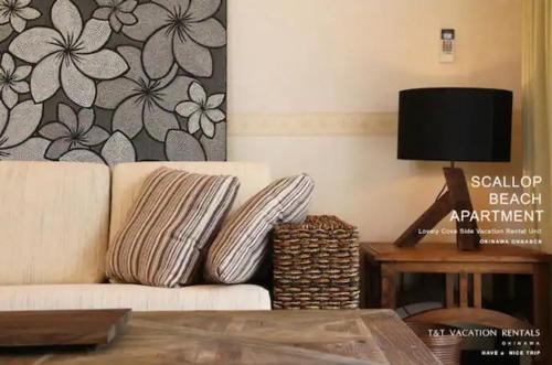 a living room with a couch and a table at Scallop Beach Condominium in Onna