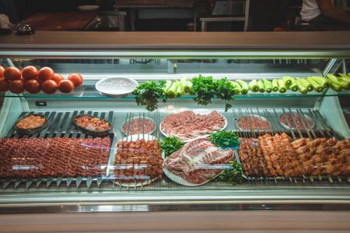 a display case filled with lots of different types of food at SPA Kompleks Raiski Kat in Dimitrovgrad
