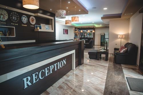 a restaurant lobby with a reception counter and chairs at SPA Kompleks Raiski Kat in Dimitrovgrad