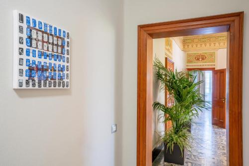 a door leading into a hallway with a picture of cups at The Rif - Boutique Hotel in Pisa