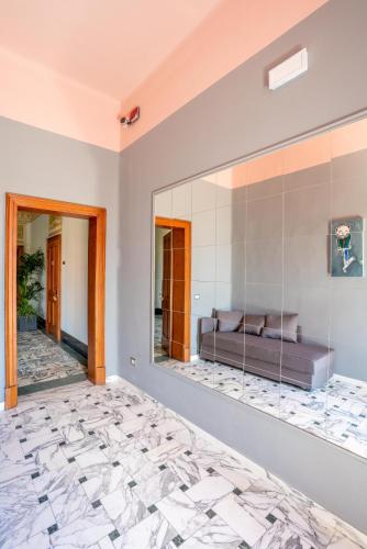 a bedroom with a large mirror and a bed at The Rif - Boutique Hotel in Pisa