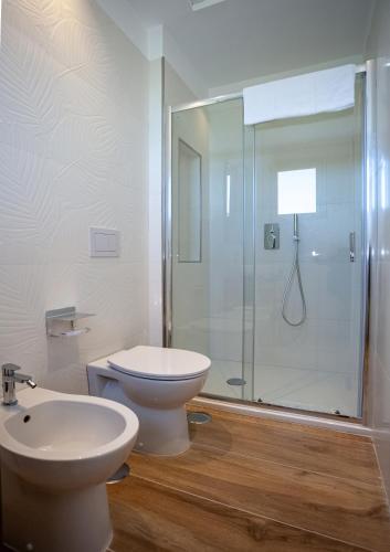 a bathroom with a toilet and a glass shower at Hotel Angelina in Sant'Agnello