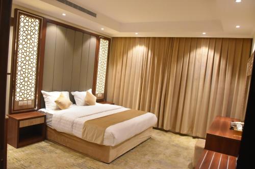 a bedroom with a large bed and a window at درة العروس للوحدات السكنية المفروشة in Jeddah