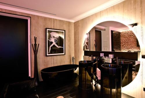 a bathroom with a bath tub and a mirror at Areadocks Boutique Hotel in Brescia