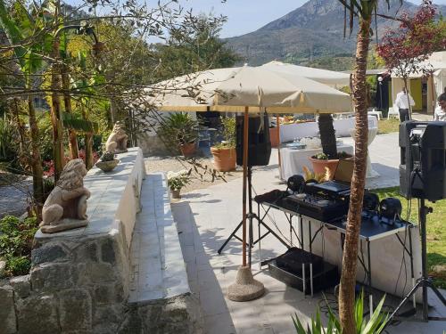 a patio with an umbrella and a table with statues at Costa Morroni in Levanto