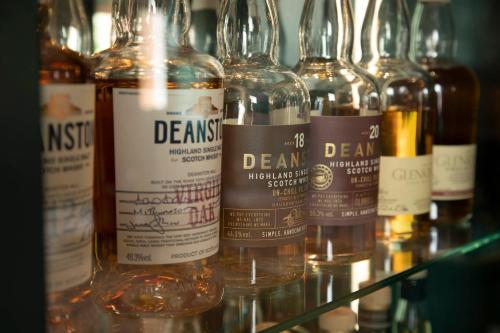a group of bottles of alcohol on a shelf at Fonab Castle Hotel in Pitlochry