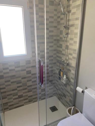 a shower with a glass door in a bathroom at BUNGALOW LA ISLA in Jávea