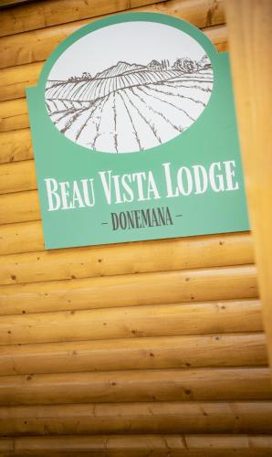 a sign for a vista lodge on a wooden wall at Beau Vista Lodge in Dunnamanagh