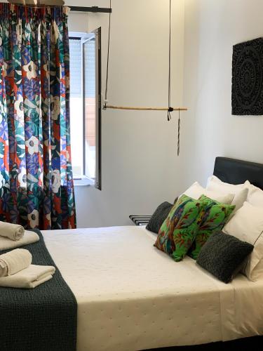 a bedroom with a bed and a window with a curtain at F.T.P Luxury Rooms in Patra
